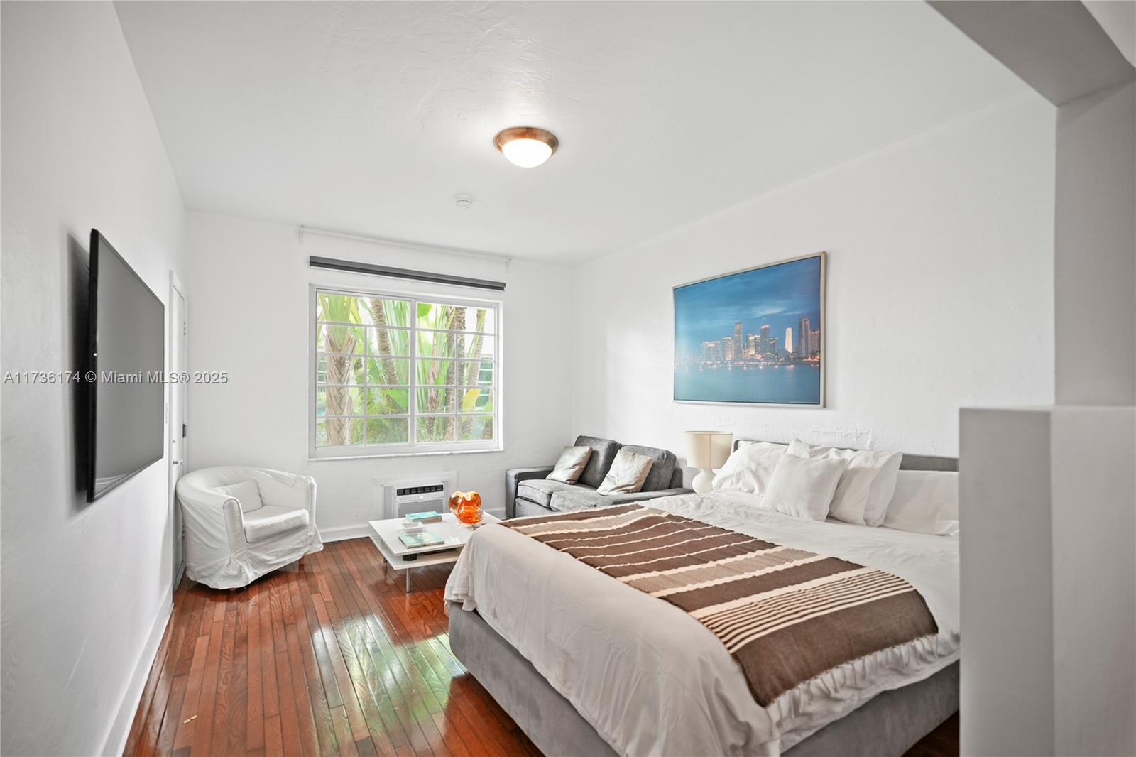 349 Meridian Avenue, Unit B102 Miami Beach, FL 33139 - Photo 1 of 14 a bedroom with a bed and a couch