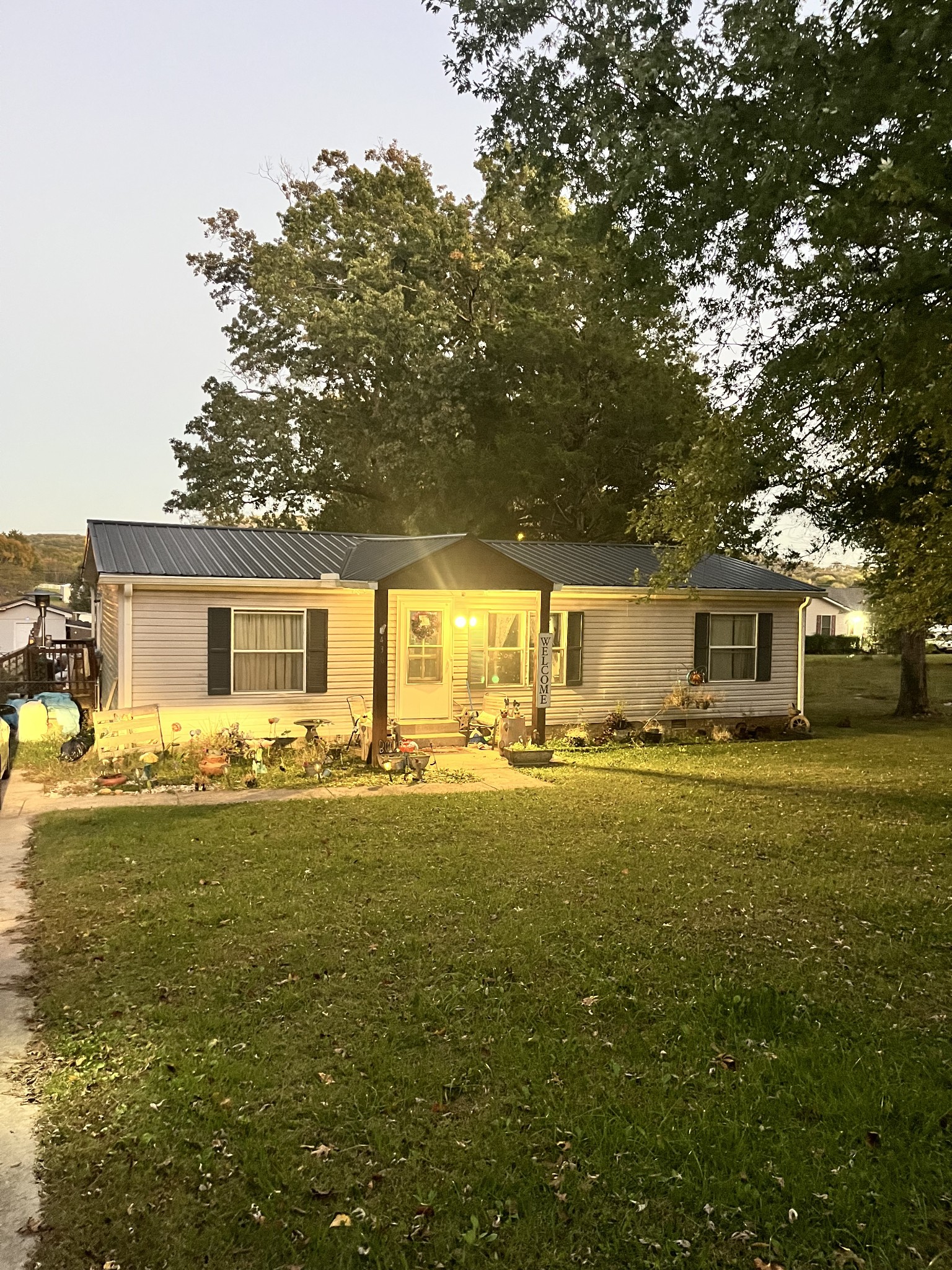 a front view of a house with a garden and yard