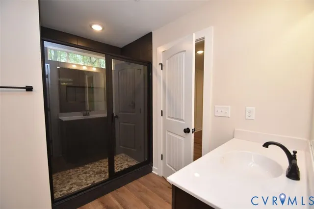 a bathroom with a shower and a sink