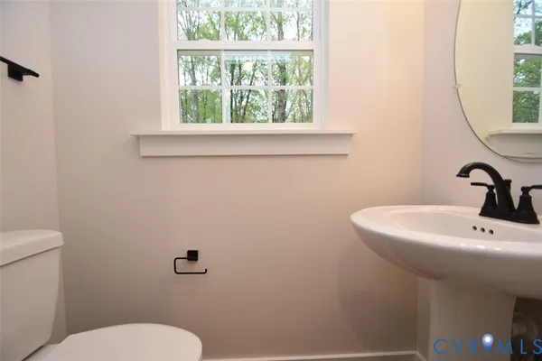 a bathroom with a sink mirror and toilet