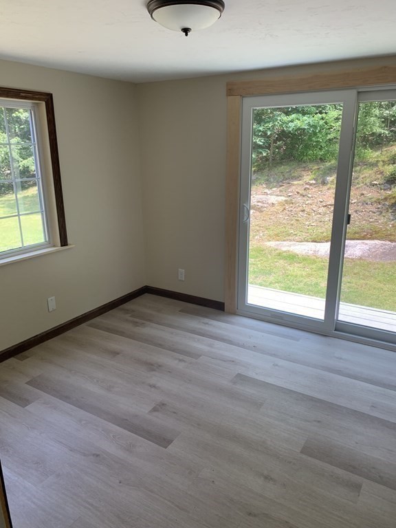 46 New Boston Road Sturbridge, MA 01566 - Photo 12 of 14 a view of an empty room with wooden floor and a window
