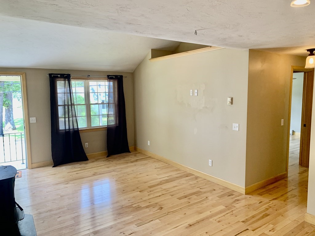 46 New Boston Road Sturbridge, MA 01566 - Photo 4 of 14 a bedroom with a bed and wooden floor