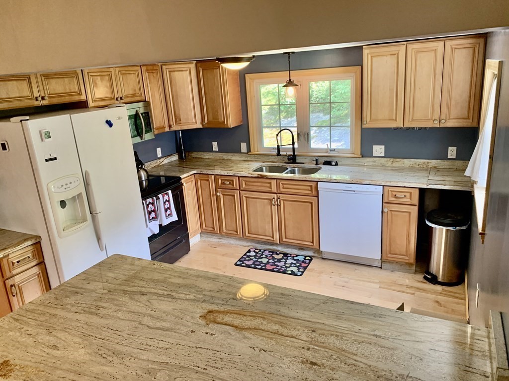 46 New Boston Road Sturbridge, MA 01566 - Photo 5 of 14 a kitchen with stainless steel appliances granite countertop a stove a sink dishwasher and a microwave