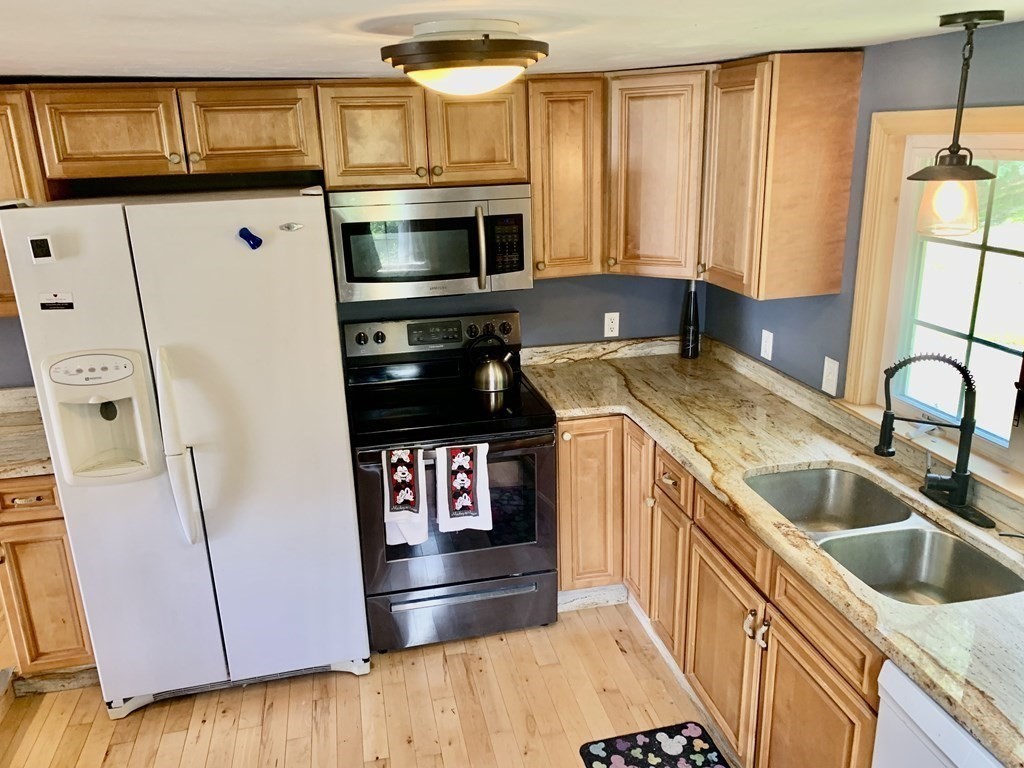 46 New Boston Road Sturbridge, MA 01566 - Photo 6 of 14 a kitchen with stainless steel appliances a stove a microwave and a sink