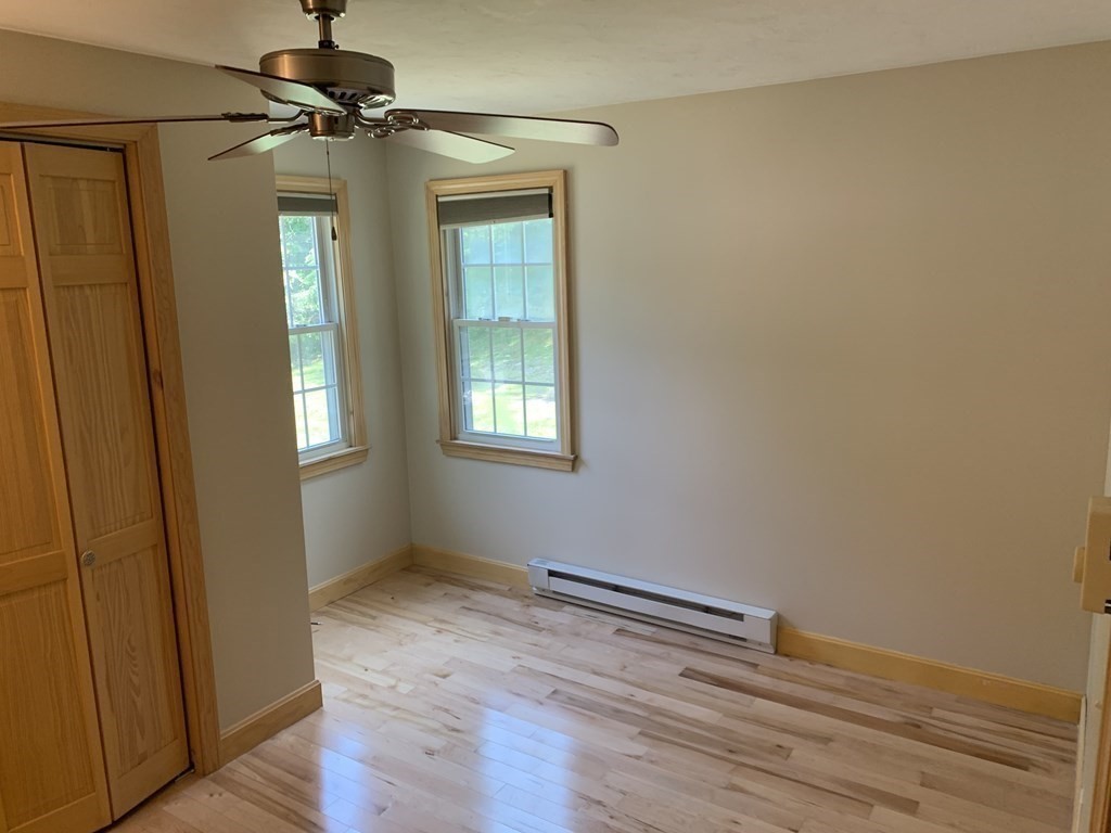 46 New Boston Road Sturbridge, MA 01566 - Photo 9 of 14 a view of empty room with wooden floor and fan