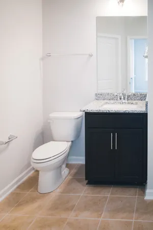 a bathroom with a sink vanity mirror and toilet