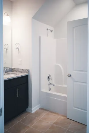 a bathroom with a bathtub and a sink