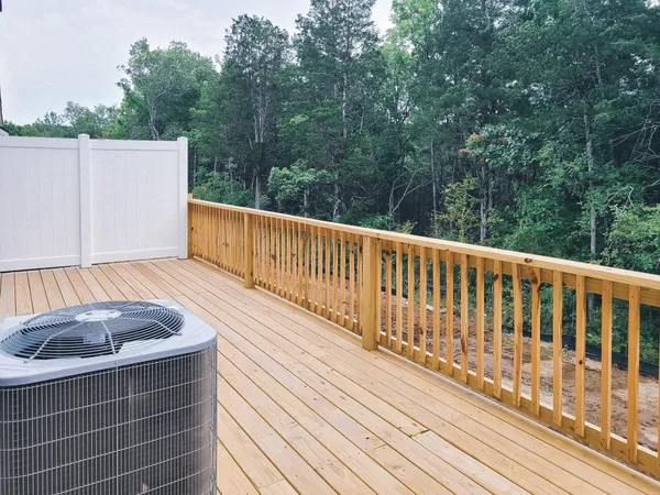 a view of balcony with wooden floor and fence