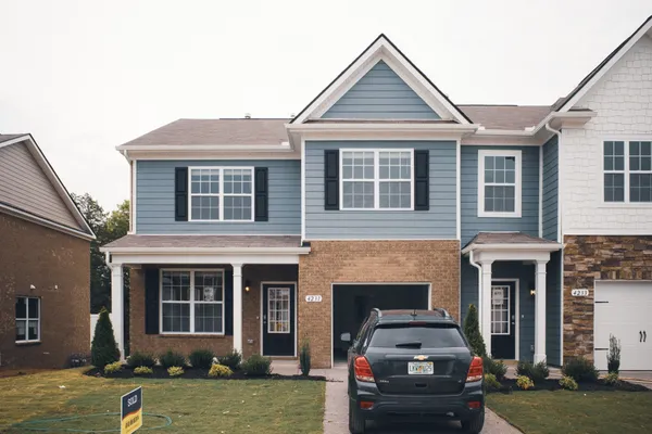 a front view of a house with a yard