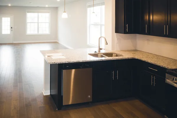 a kitchen with stainless steel appliances granite countertop a sink and a granite counter tops
