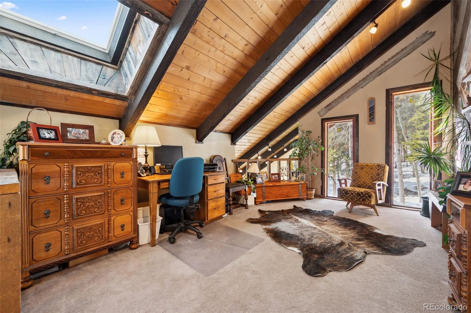 266 Lodgepole Drive Evergreen, CO 80439 - Photo 18 of 45 a view of a room with lots of windows