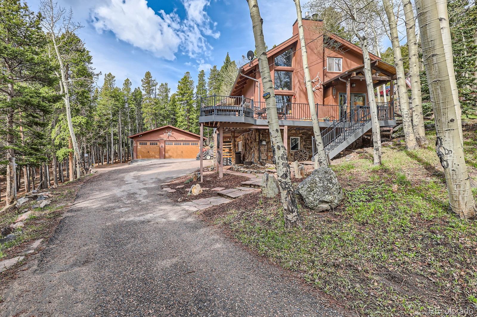 266 Lodgepole Drive Evergreen, CO 80439 - Photo 2 of 45 a view of a house with a yard and sitting area
