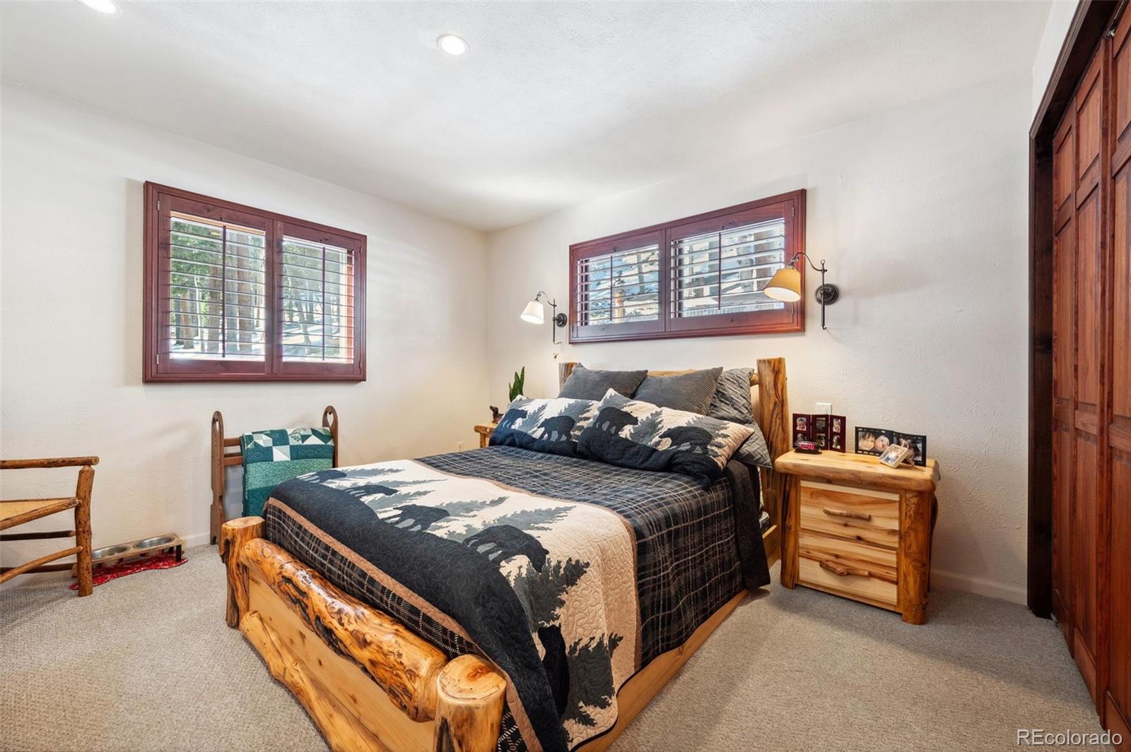 266 Lodgepole Drive Evergreen, CO 80439 - Photo 27 of 45 a bedroom with a bed and a dresser next to a window
