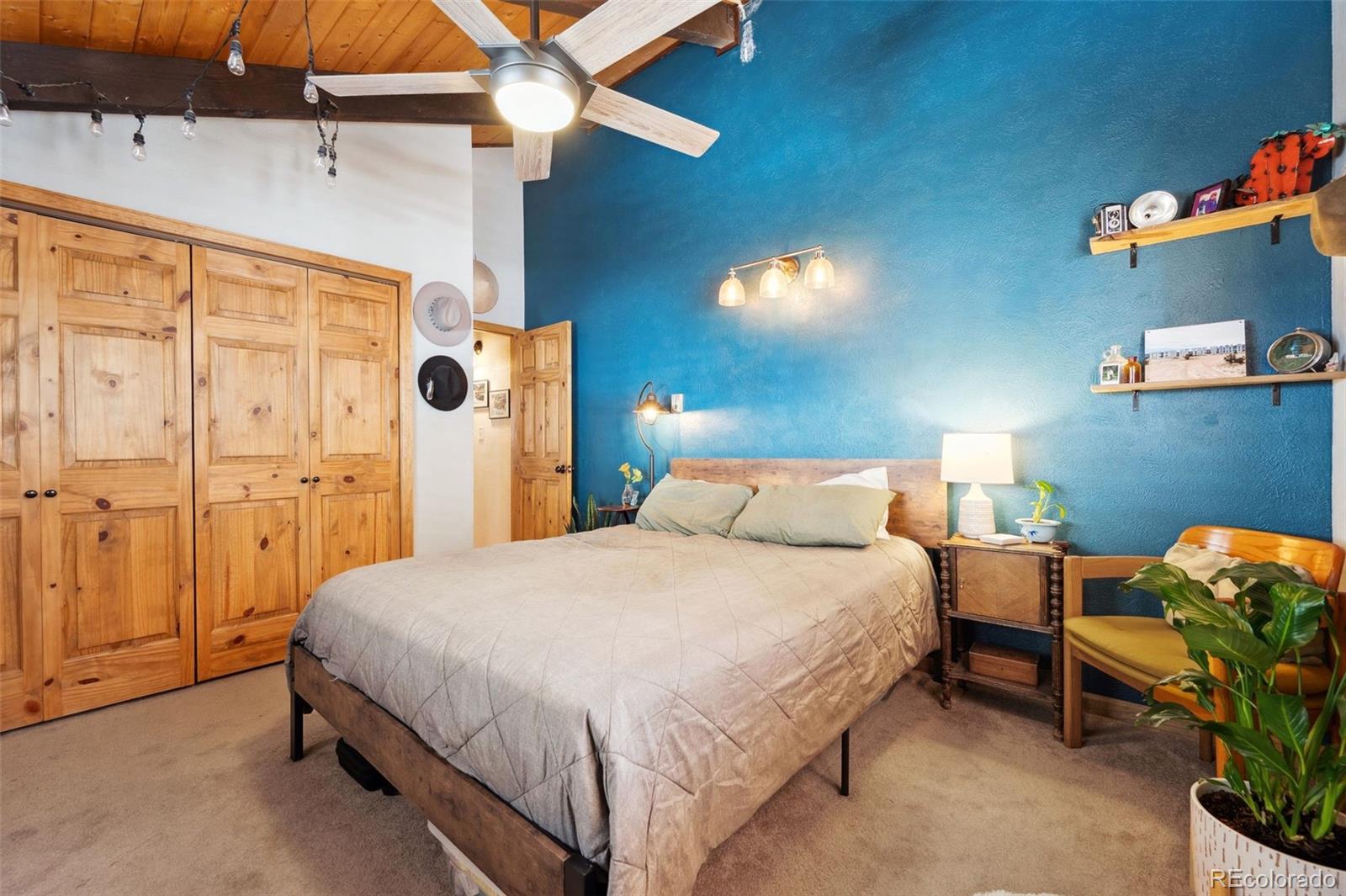 266 Lodgepole Drive Evergreen, CO 80439 - Photo 29 of 45 a bedroom with a bed and a chandelier