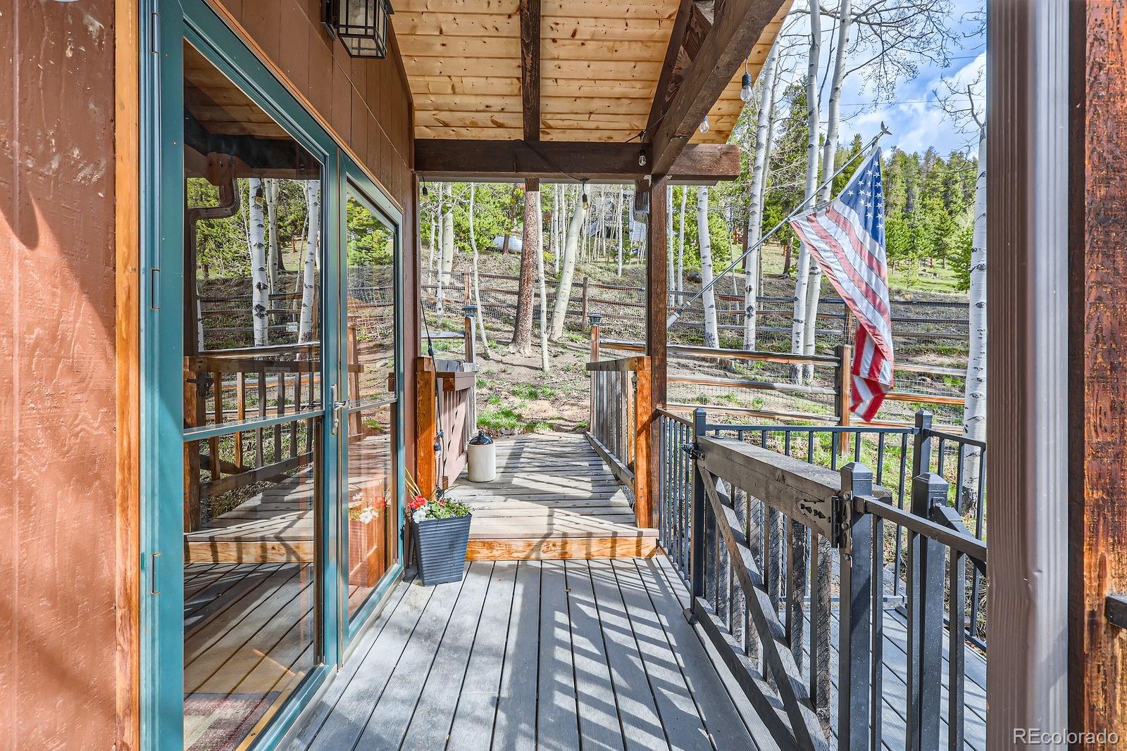 266 Lodgepole Drive Evergreen, CO 80439 - Photo 37 of 45 a view of a porch with wooden floor and furniture