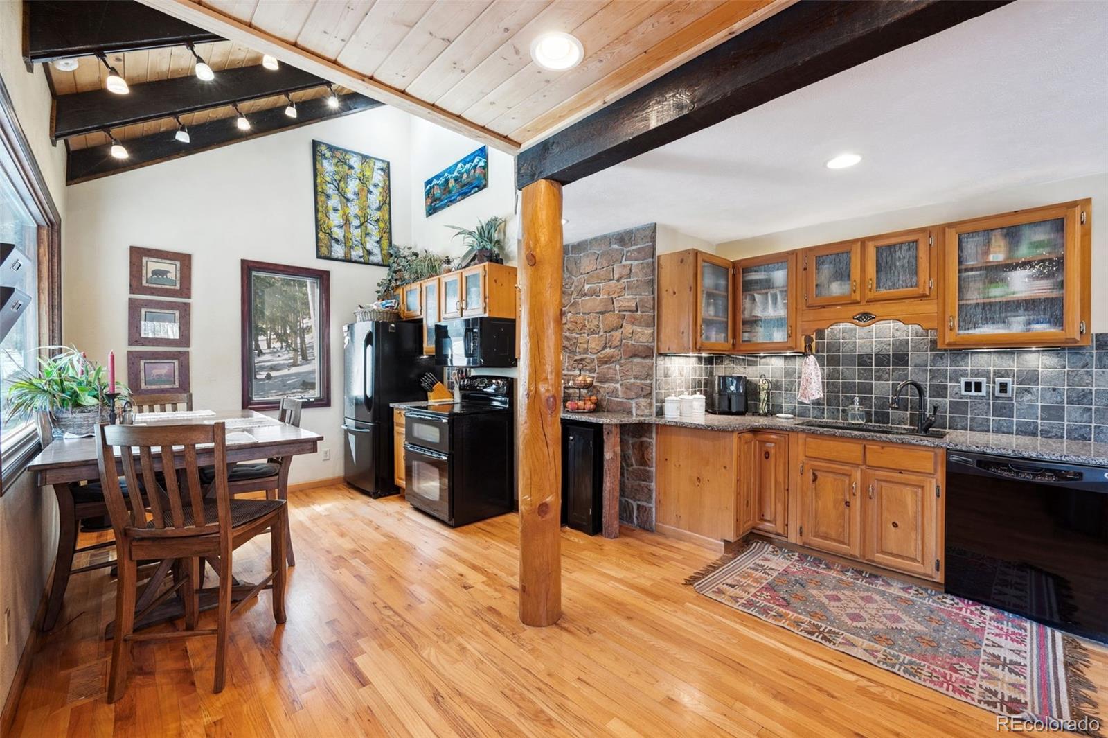 266 Lodgepole Drive Evergreen, CO 80439 - Photo 5 of 45 a open kitchen with stainless steel appliances granite countertop a stove and refrigerator