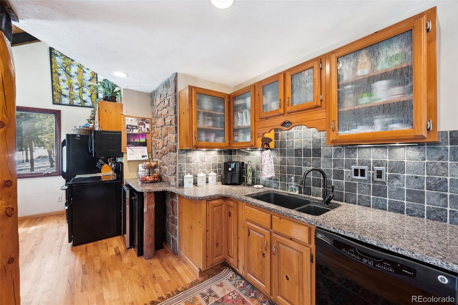 266 Lodgepole Drive Evergreen, CO 80439 - Photo 6 of 45 a kitchen with a sink stove and cabinets