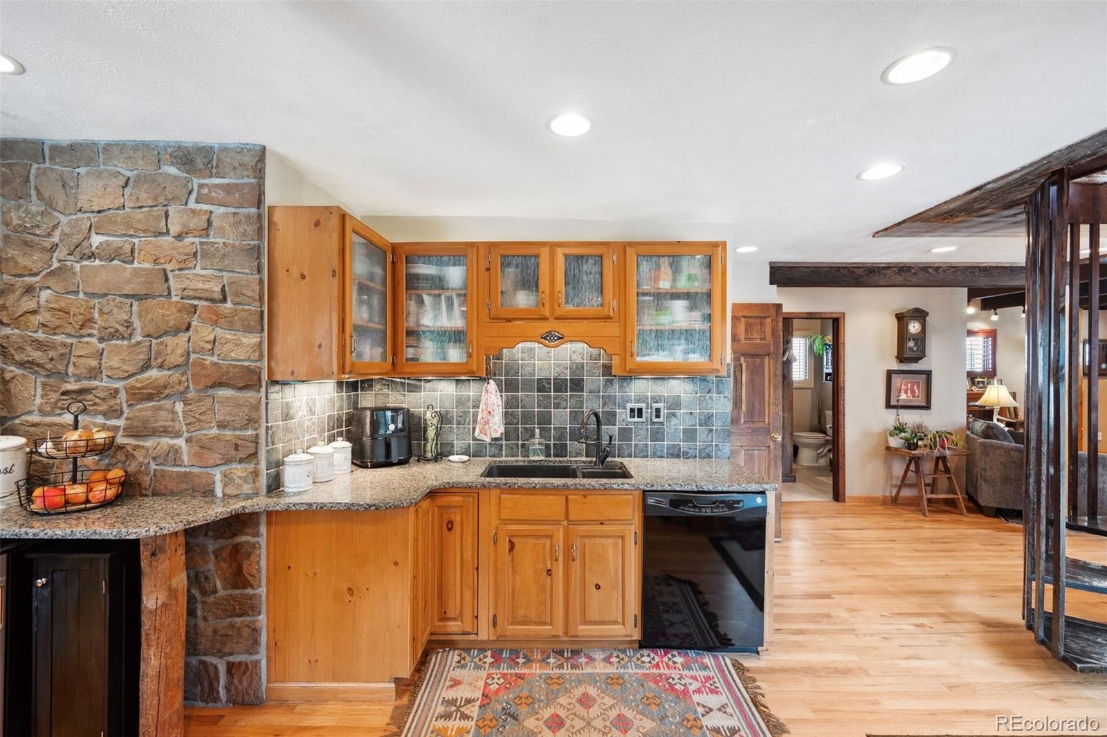 266 Lodgepole Drive Evergreen, CO 80439 - Photo 7 of 45 a kitchen with stainless steel appliances granite countertop a sink and cabinets