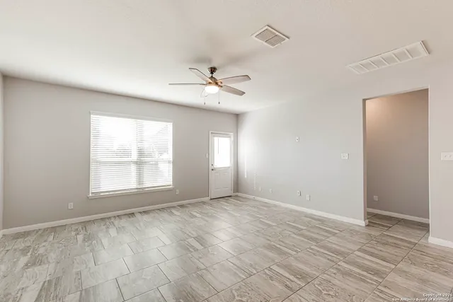 a view of a kitchen with kitchen island a sink wooden floor and a refrigerator