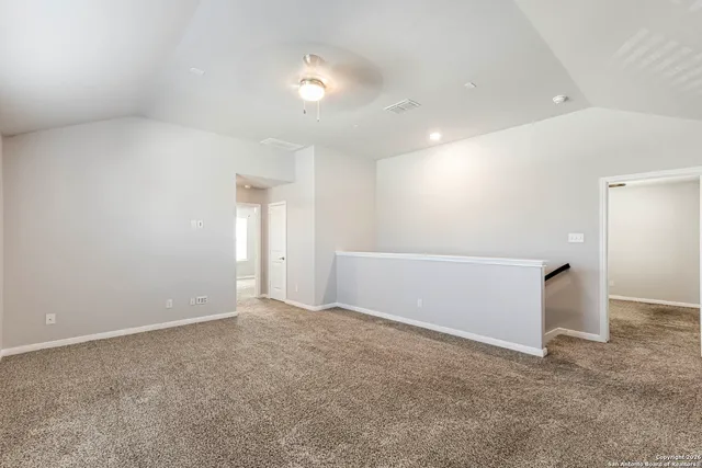 an empty room with closet and fan