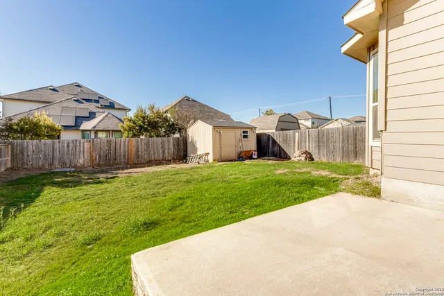 a view of a house with yard and a fence