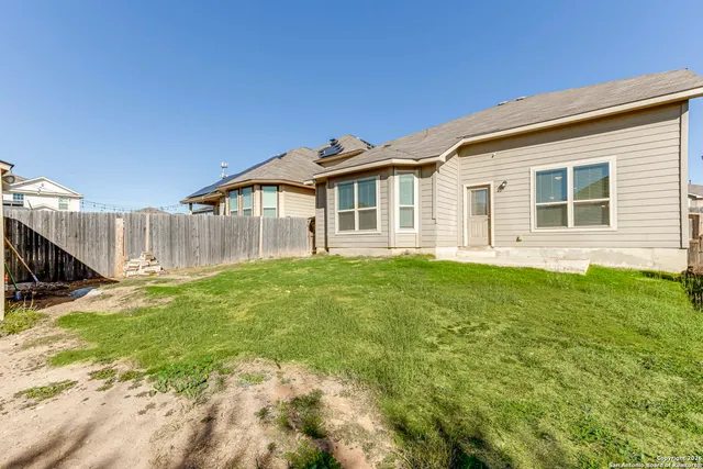 a view of a house with a backyard
