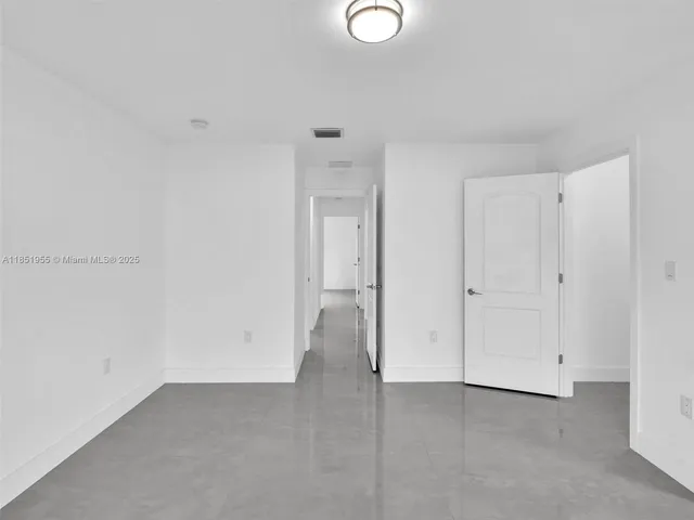 a bathroom with a toilet sink vanity and mirror