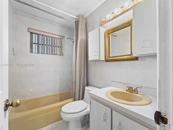 a bathroom with a toilet a sink and shower