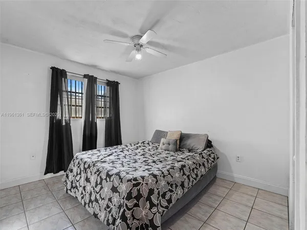 a bedroom with a bed and a cabinet