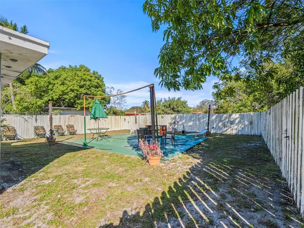 a backyard of a house with table and chairs