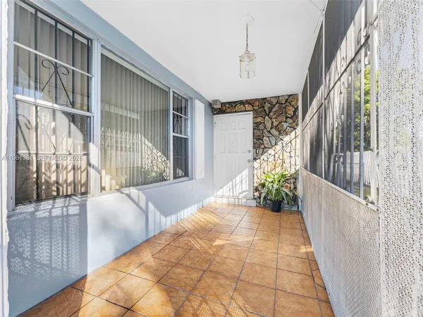 a view of a swimming pool with a lawn chairs under an umbrella