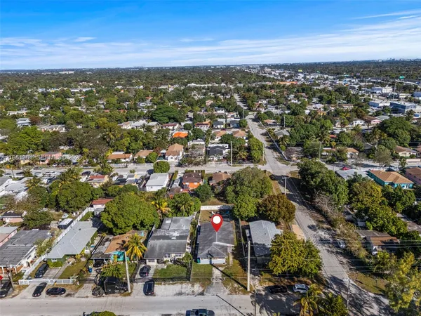 a view of a backyard with wooden fence