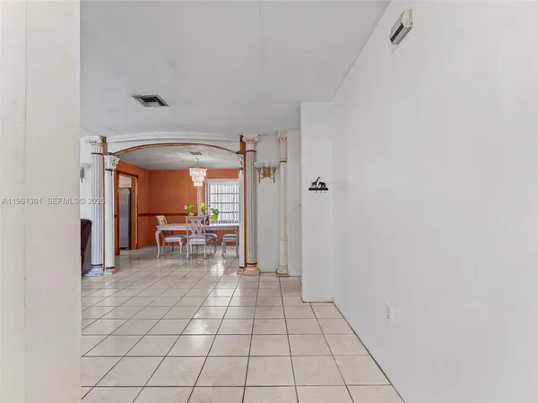a view of a room with wooden floor and furniture