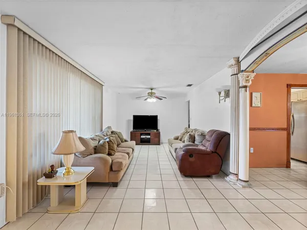 a living room with furniture a fireplace and a large window