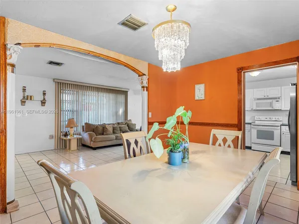 a view of kitchen island with furniture and chandelier