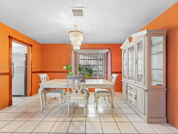 a view of a dining room with furniture wooden floor and chandelier