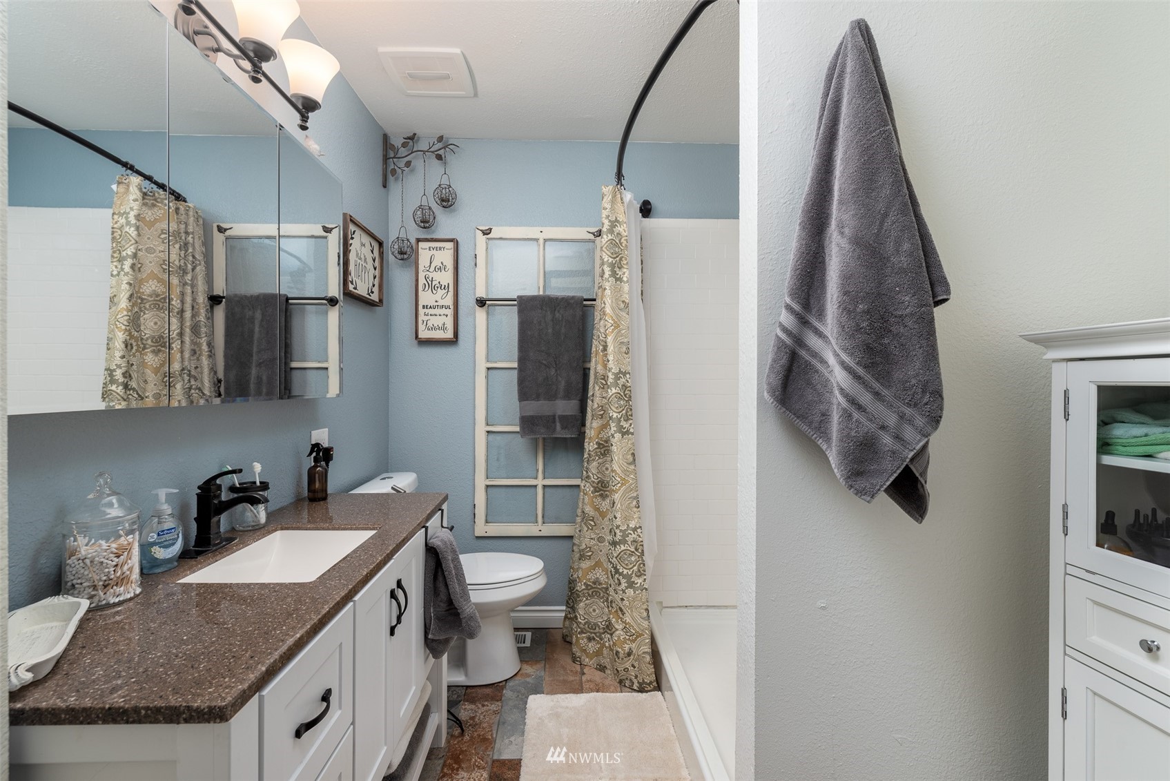 6093 Captain's Way Ferndale, WA 98248 - Photo 14 of 32 a bathroom with a granite countertop sink a toilet and shower
