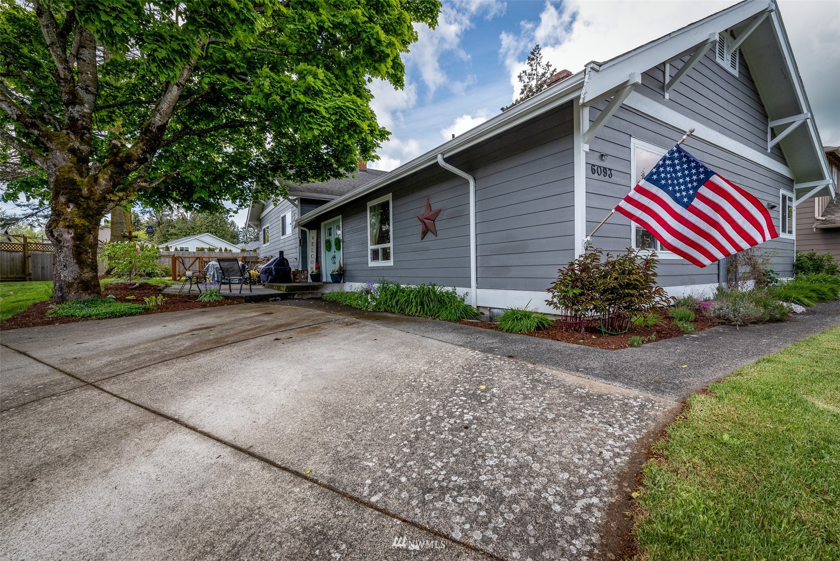6093 Captain's Way Ferndale, WA 98248 - Photo 2 of 32 a front view of a house with a yard and garage