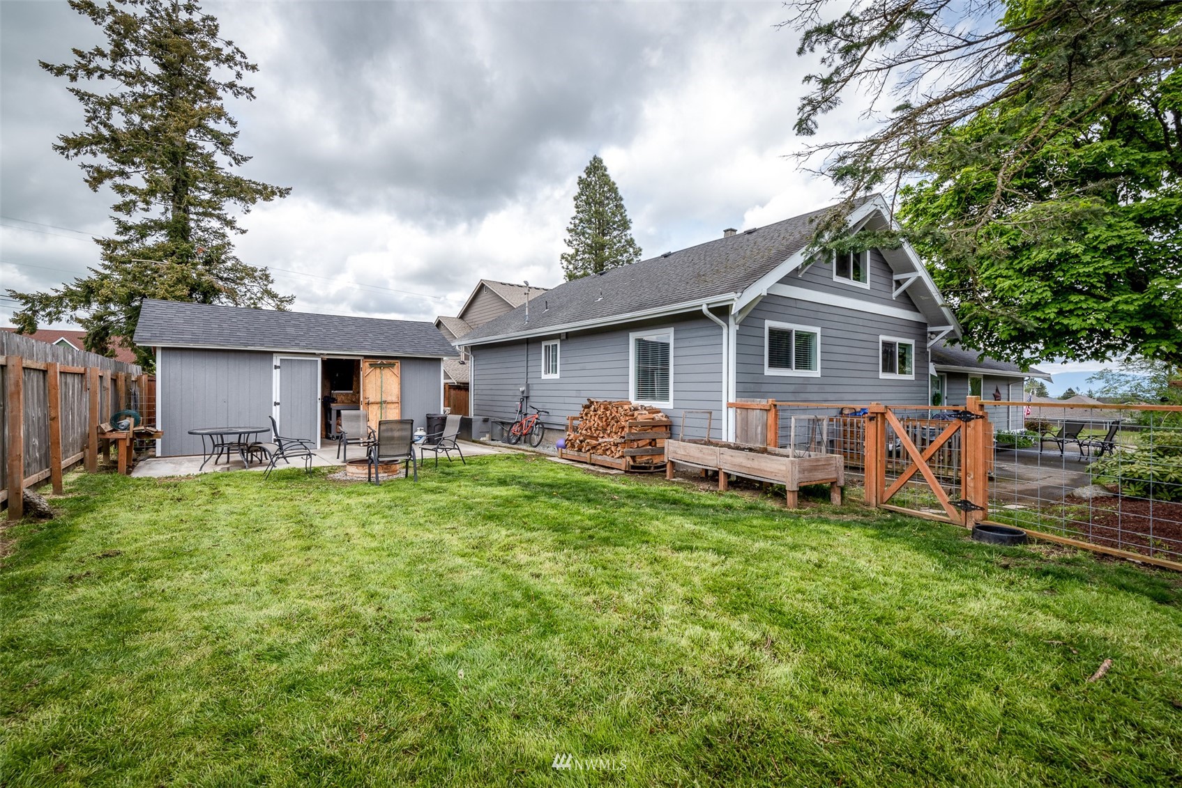 6093 Captain's Way Ferndale, WA 98248 - Photo 23 of 32 a front view of a house with a garden and trees