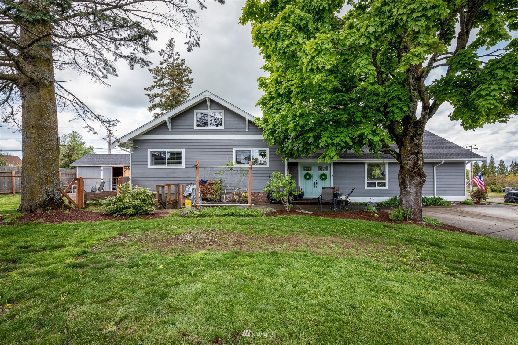 6093 Captain's Way Ferndale, WA 98248 - Photo 26 of 32 a front view of a house with a garden and trees
