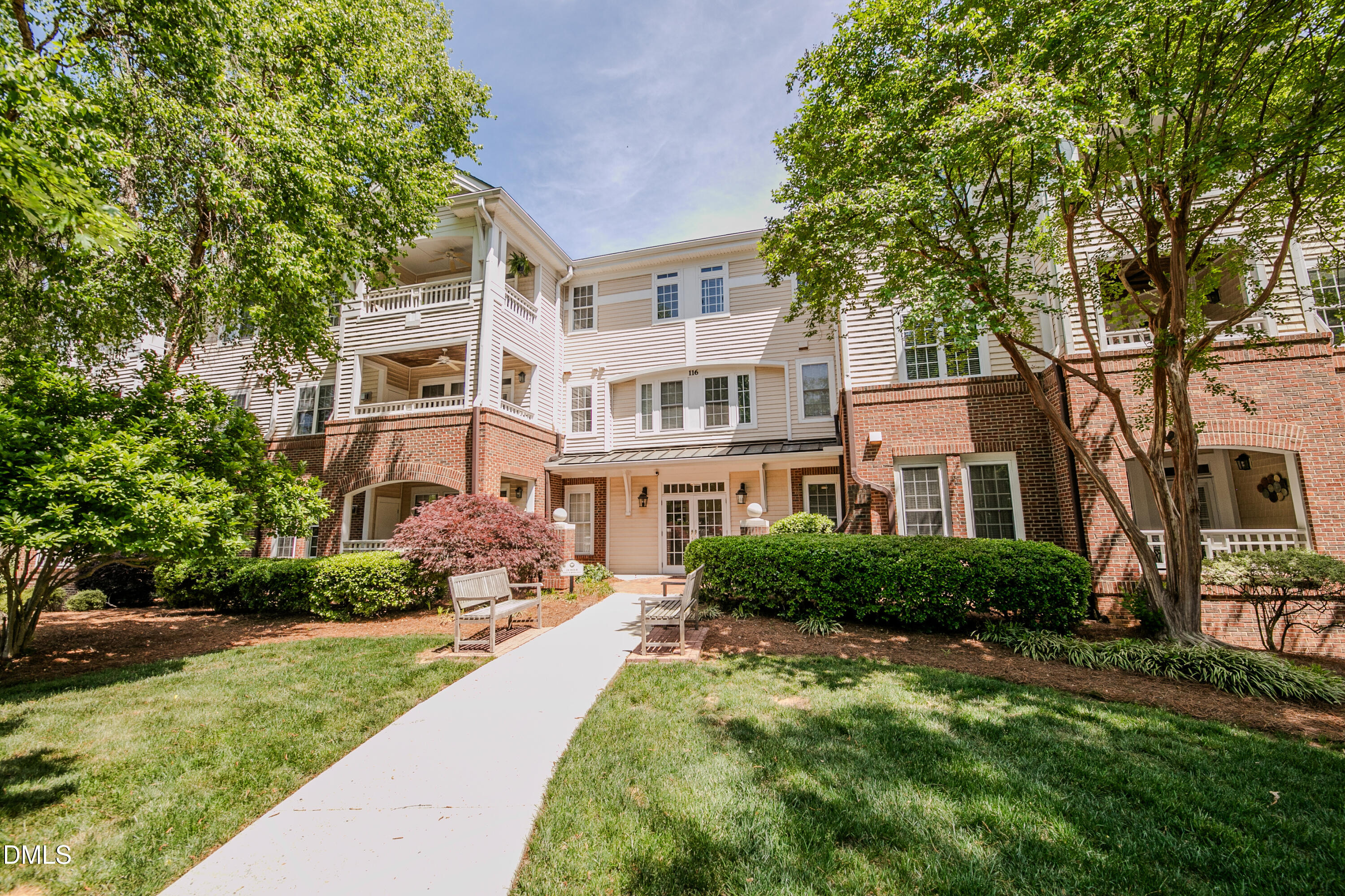 116 Northbrook Drive, Unit 305 Raleigh, NC 27609 - Photo 1 of 43 a front view of a house with a yard and trees