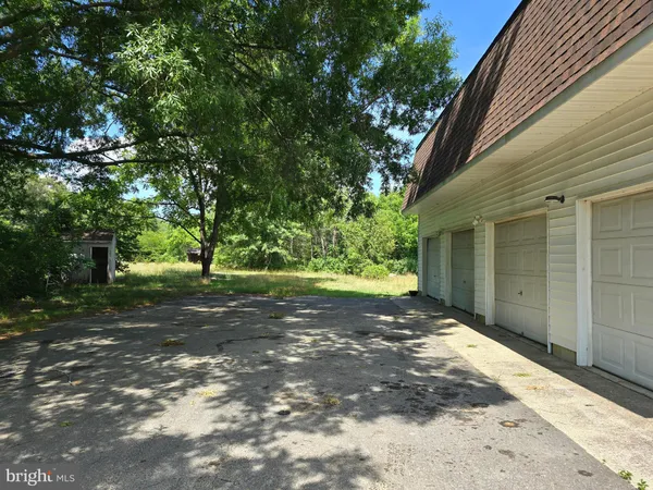 a view of a house with yard and tree s