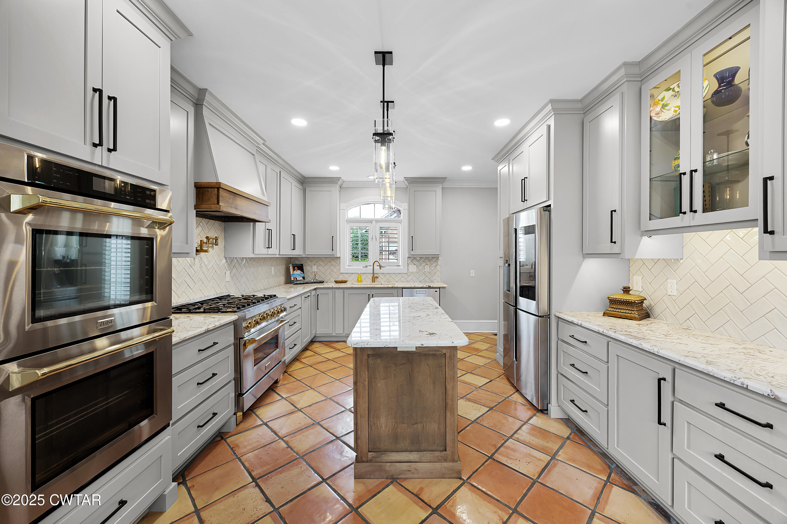 40 Winfield Place Jackson, TN 38305 - Photo 4 of 37 a kitchen with stainless steel appliances kitchen island granite countertop a stove a sink and a refrigerator