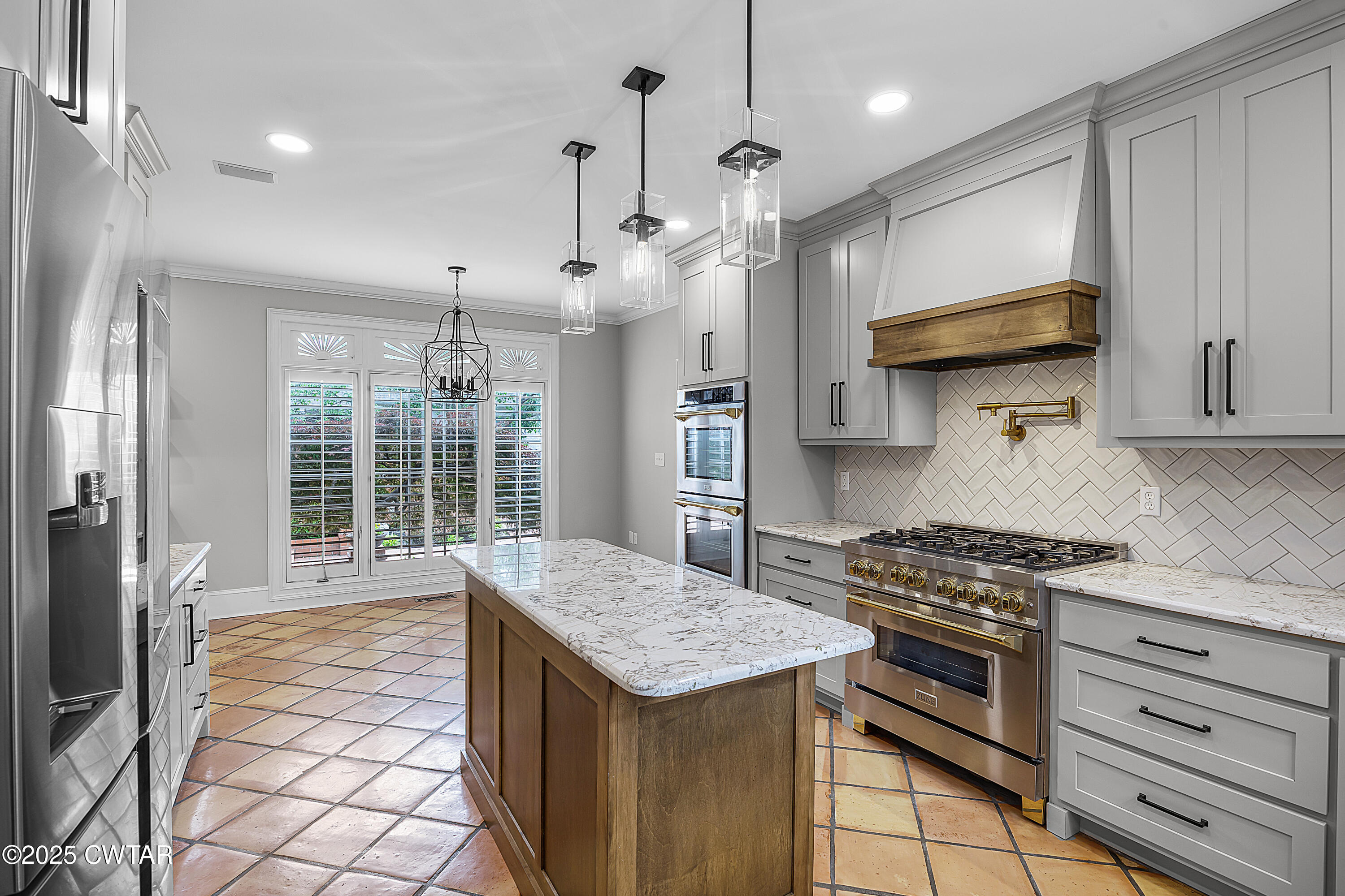 40 Winfield Place Jackson, TN 38305 - Photo 7 of 37 a kitchen with granite countertop a stove a sink a refrigerator and a wooden cabinets