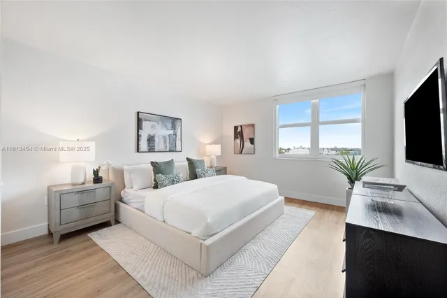 a bedroom with a large bed and a flat screen television