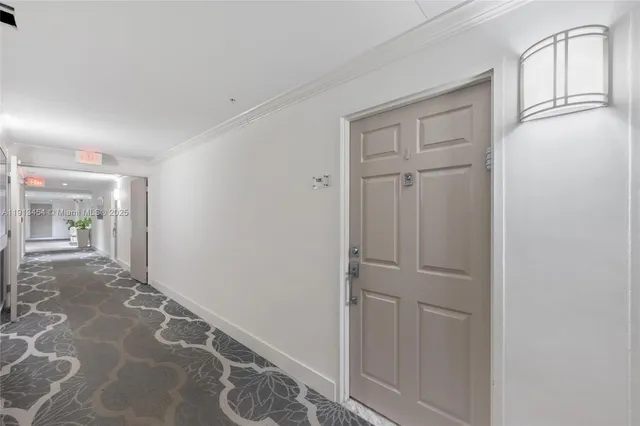 a view of a livingroom with wooden floor and windows