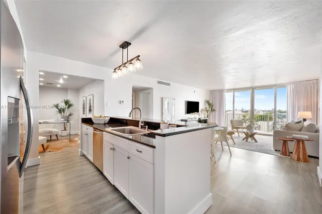 a kitchen with stainless steel appliances a stove top oven and a refrigerator