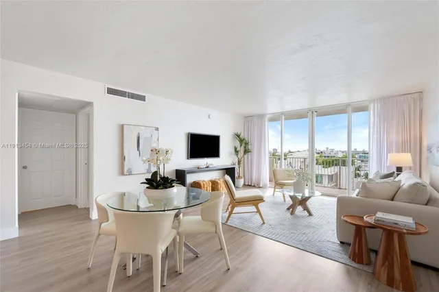 a dining room with furniture and wooden floor
