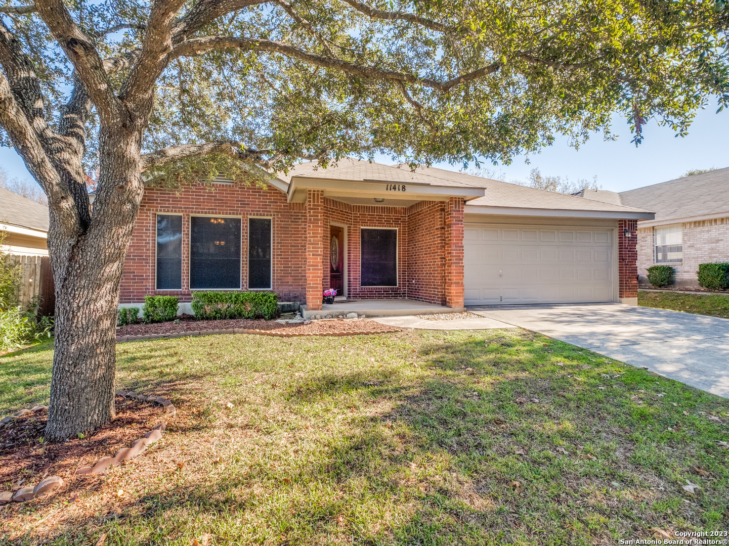 a front view of house with yard and trees around