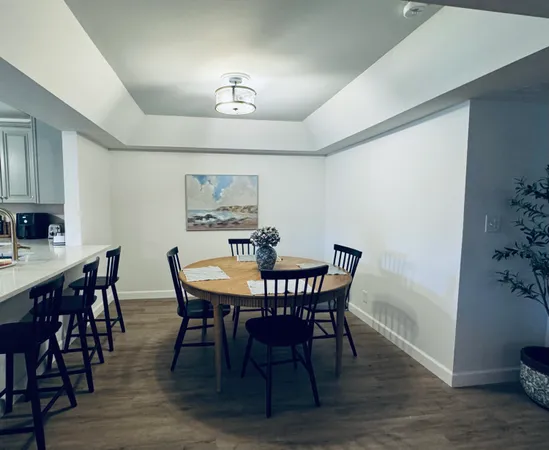 a view of a dining room with furniture and wooden floor
